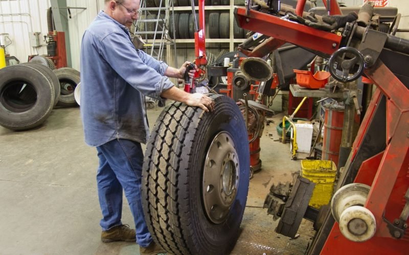 a used tire dealer checking tire
